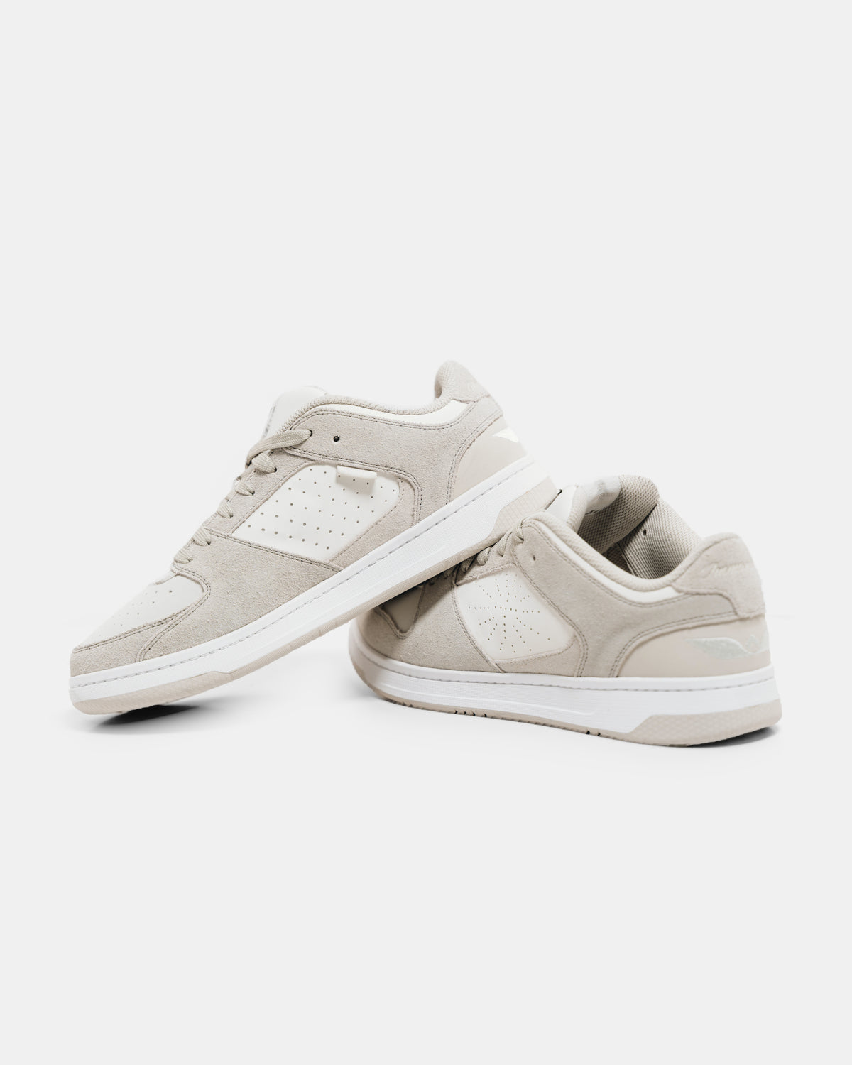 Two Immanuel 1 Tan sneakers, one resting on the other